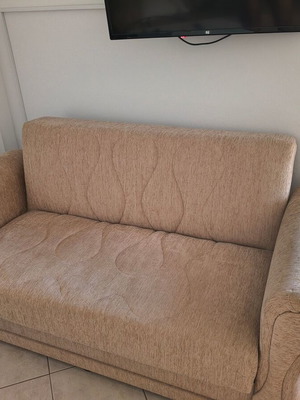 Two-seater sofa bed, beige fabric with storage