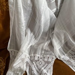 Large white table linen used with lace
