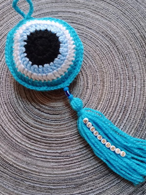 Crocheted evil eye handmade for baby stroller or crib