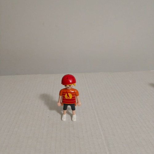 Playmobil figure with orange-red shirt and helmet used