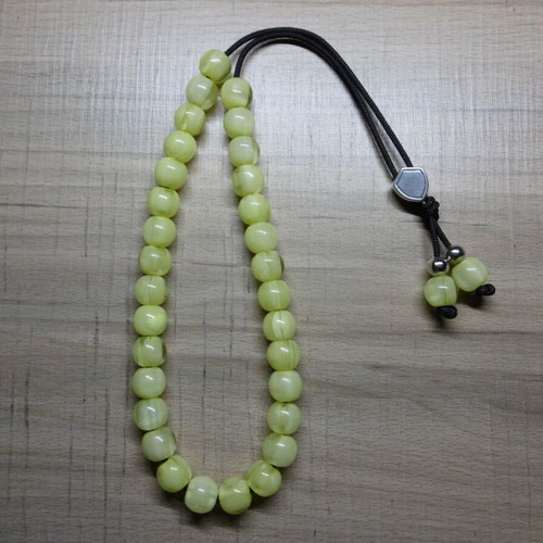 Handmade komboloi with acrylic beads and silver emblem