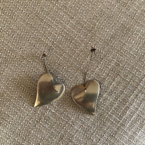 Silver earrings used in heart shape