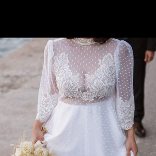 Romantic vintage-inspired wedding dress with polka dot tulle and lace