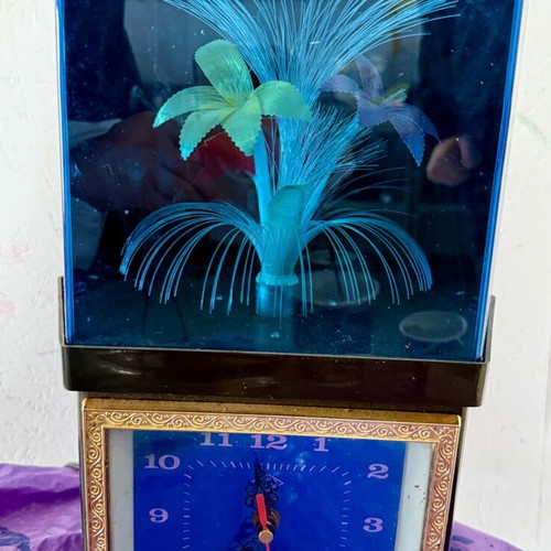 Vintage clock with optical fibers and rotating flower used