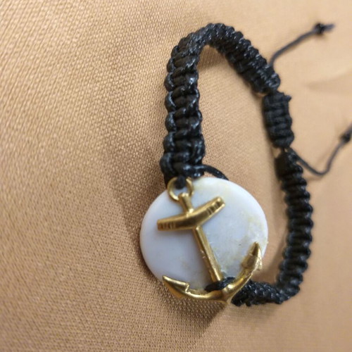Macrame bracelet with gold anchor on white base