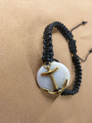 Macrame bracelet with gold anchor on white base