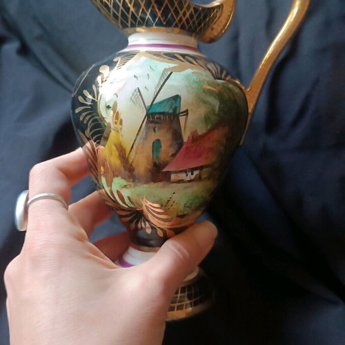 Antique porcelain jug used with hand-painted windmill scene