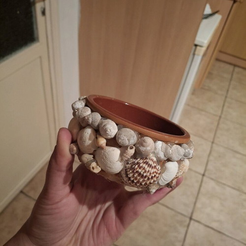 Handmade flowerpot like new made of seashells