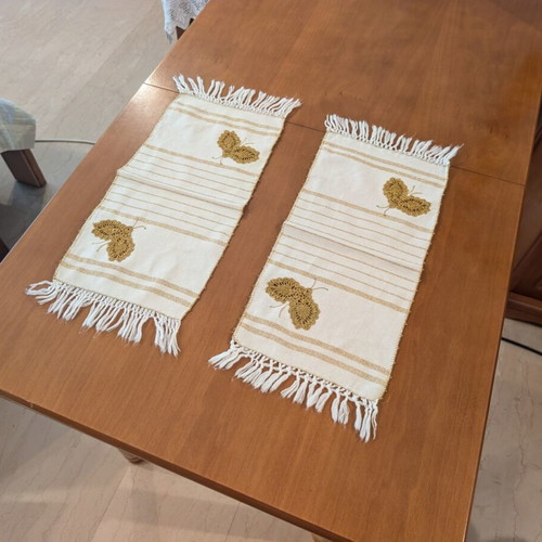 Set of three table linens with handmade golden knitted butterfly, used