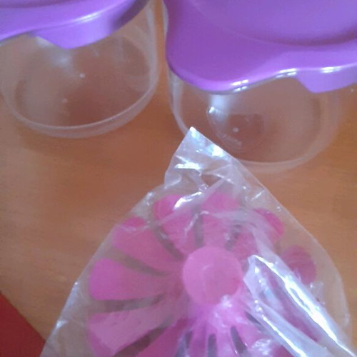 Tupperware product set new with collectible spatula and small cups