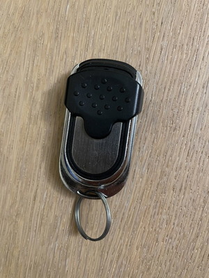 Remote control with cover for garage doors and gates