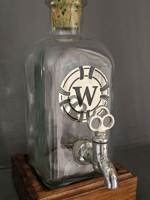 Antique liquor bottle with spigot and wooden base used