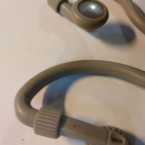 Over the ear headphones used with anatomical tube behind the ear