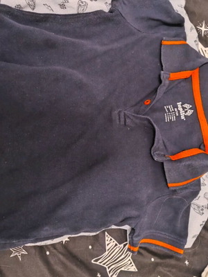 Blue polo-style kids shirt like new with orange details, size 104 cm