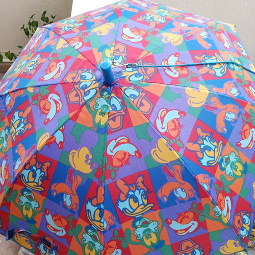 Disney umbrella used with blue Mickey Mouse handle, multicolored