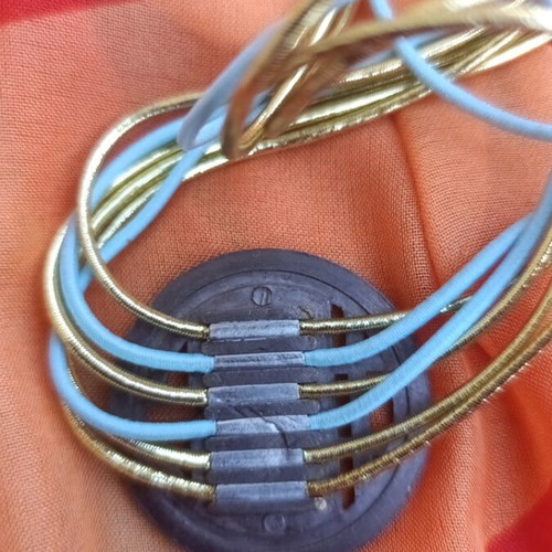 Metal necklace with turquoise and gold elastic cords