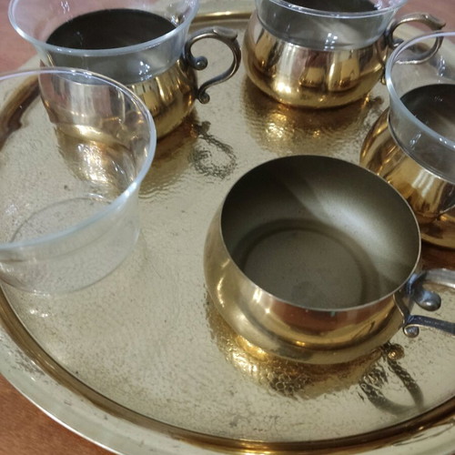 Bronze tea cups with glass on tray used