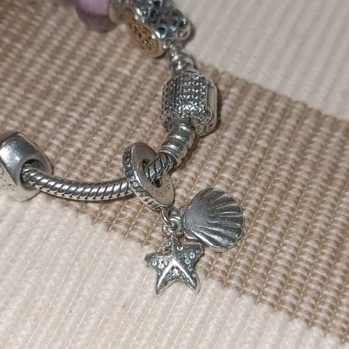 Pandora silver bracelet with 11 charms and collectible clasp, like new