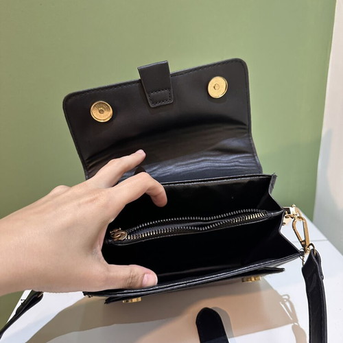 Black women's crossbody shoulder bag with gold details