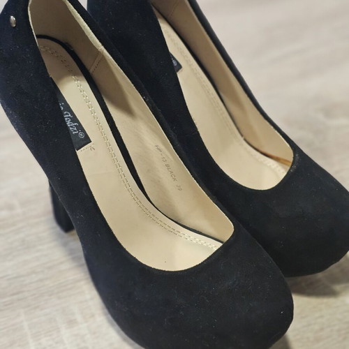Black suede high heels with gold zipper