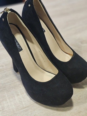Black suede high heels with gold zipper