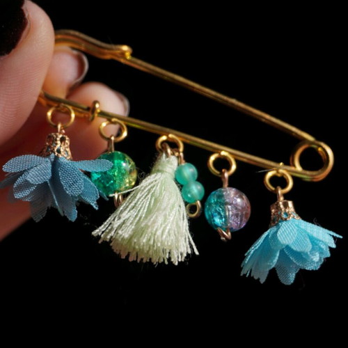 Handmade brooch with dangling elements in light blue and turquoise