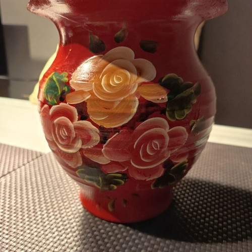 Handmade traditional clay vase with painted flowers