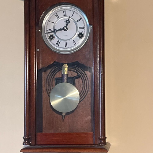 Wooden wall clock like new with pendulum and Roman numerals