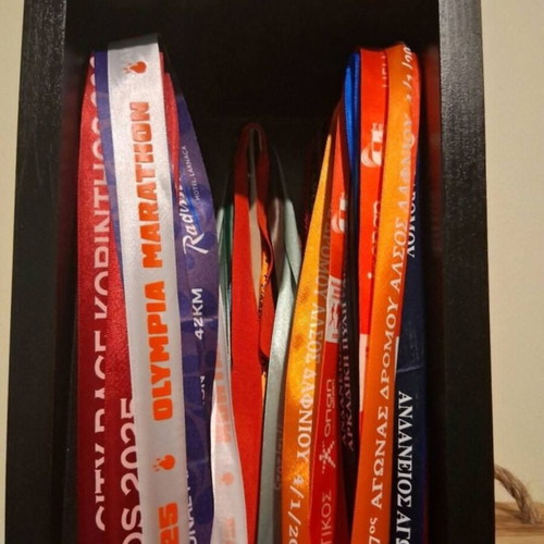 Handmade wooden medal display case with running race medal collection used