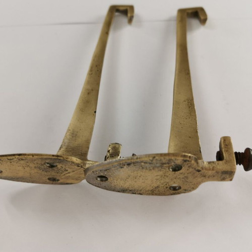 Pair of brass curtain hooks with clamp used