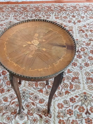 Antique marquetry table used with bronze garland