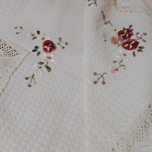 Embroidered tablecloth like new with satin ribbon and floral motifs