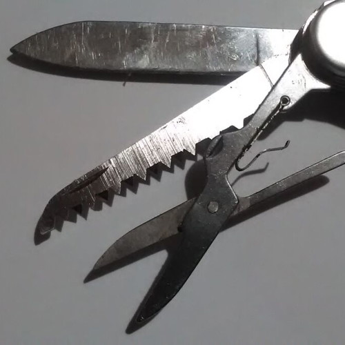 Swiss multi-tool knife with metal handle and multiple tools