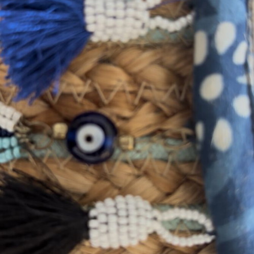 Woven clutch bag with ornamental details