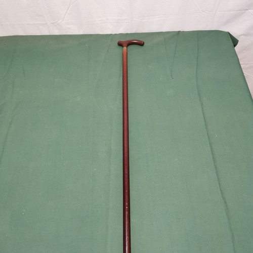 Wooden walking cane used, dark brown color