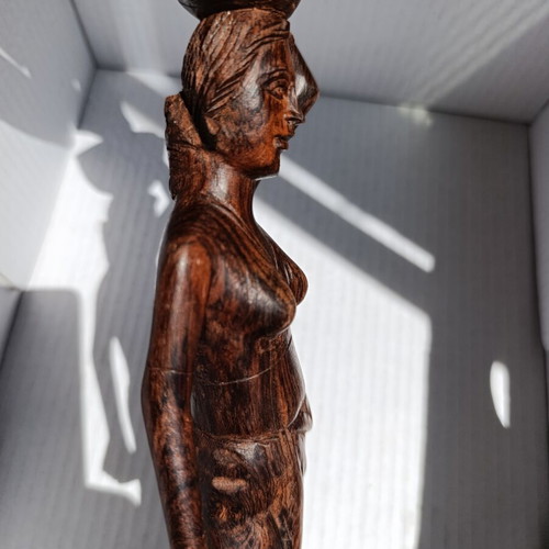 Rosewood figure of woman with basket from Bali, like new
