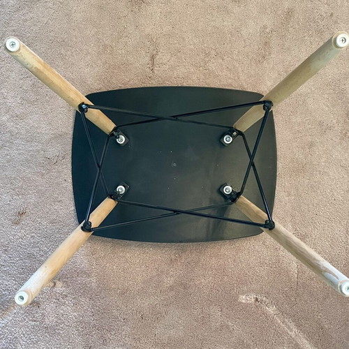 Low stool like new with black curved plastic seat and wooden legs