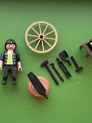 Playmobil blacksmith figure with whetstone wheel, cart wheel, anvil set