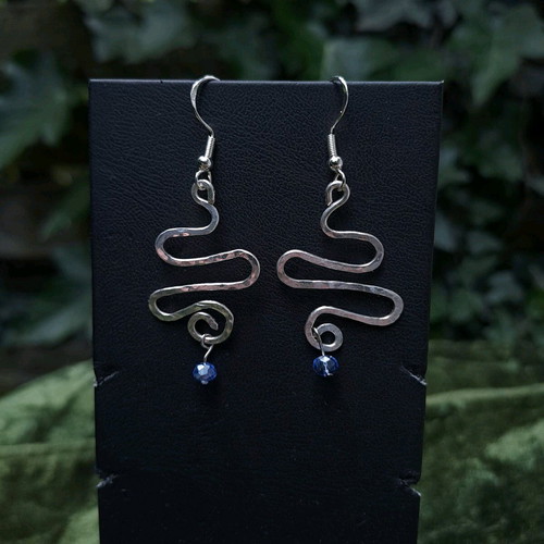 Swirly silver earrings with light blue crystal new