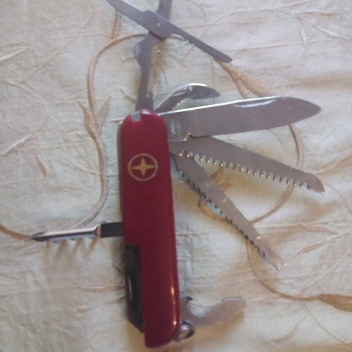 Multitool pocket knife like new with saws, screwdriver, scissors, and more