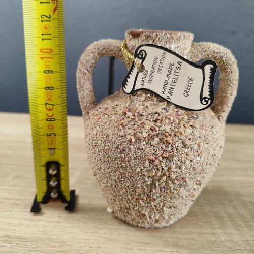 Handmade ceramic amphora decorative vase on metal base used