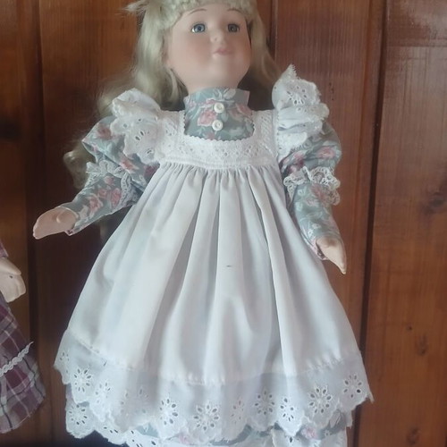 Porcelain doll like new with vintage lace dress and floral details
