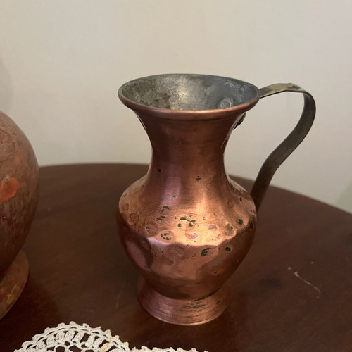 Two decorative hammered copper vases used with natural patina