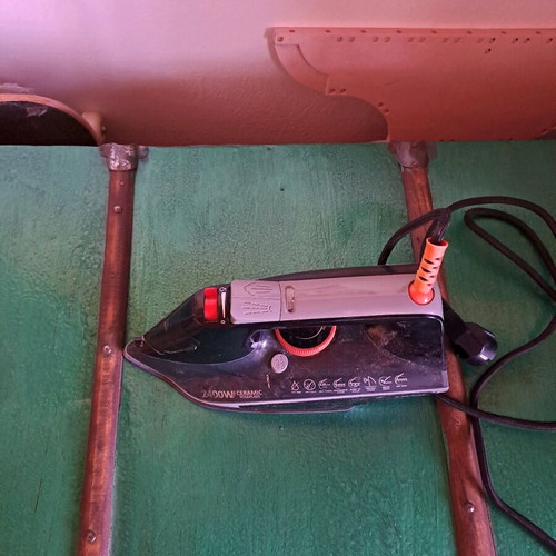 Steam iron used, as shown
