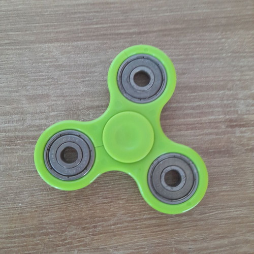 Fidget spinner used, metal with wear