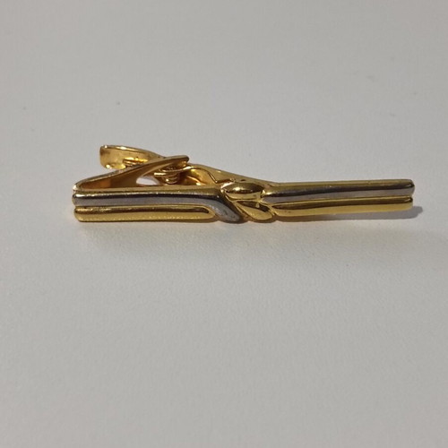 Tie clip used, gold color with silver accents