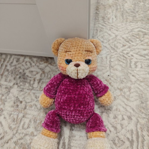 Amigurumi knitted teddy bear with velvet pajamas and sleep hat