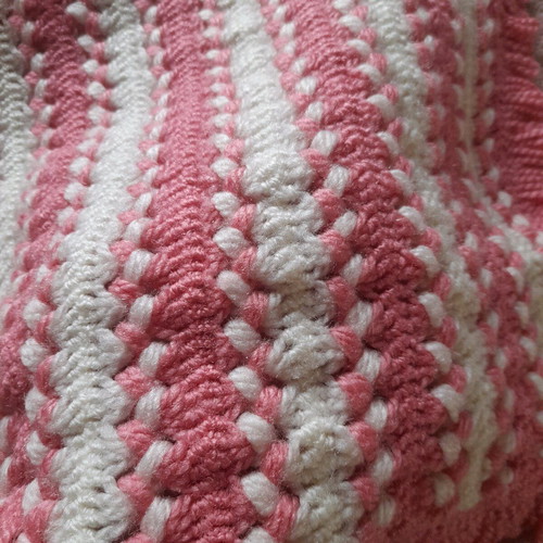 Knitted handmade crib blanket used pink white