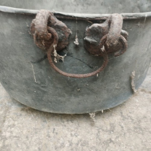 Large handmade bronze cauldron used with iron handles