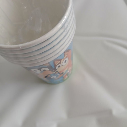 Bluey birthday party set with invitations, straws, cups, knives, and banner